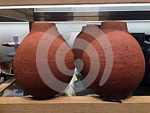 Big decorative terracotta vases on a shelf photo