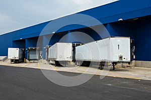 Big distribution warehouse with gates for loads and trucks photo