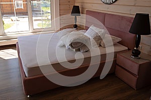 Big double bed with two white pillows and white blanket in the luxury hotel