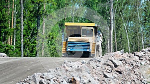 Big dump truck is moving along the highway