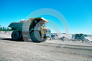 Big dump truck is moving along the highway