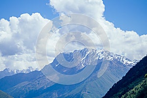 Big Elbrus mountain in summe on cloudy day