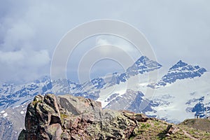 Big Elbrus mountain in summe on cloudy day.