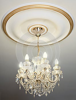 Big electric chandelier on ceiling