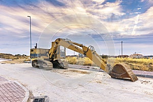 Big excavator moving earth in the construction works of a road