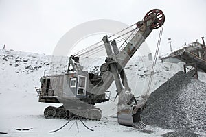 Big Excavator to load crushed iron ore, crushed stone, rocks.