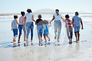 Big family, beach walk and water for vacation, sunshine and bonding with interracial diversity by waves. Happy family