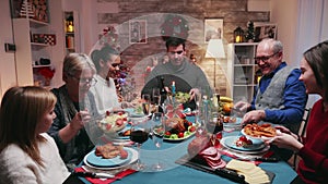 Big family celebrating christmas with delicious food