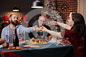 Big family celebrating christmas, eating traditional food at table