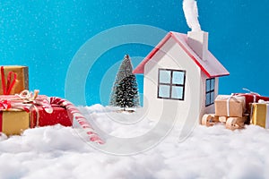 Big family celebrating christmas in little white house having smoke outdoors red brown gift box wooden sledges evergreen