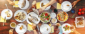 Big family dinner in process. Top view vertical image on table w