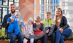 Big family with four kids having rest in town.