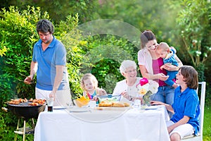 Big family grilling meat for lunch