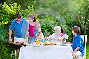 Big family grilling meat for lunch