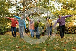 Big family having fun together in autumnal park