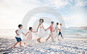 Big family, holding hands and walking at the beach for travel, vacation and adventure in nature. Love, freedom and