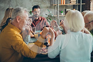 Big family of mature father mother small boy little girls pensioner celebrate fall october feasting holiday thanksgiving