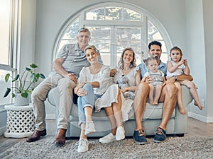 Big family, portrait and generations relax together on couch in living room at home. Happy grandparents, mother smile