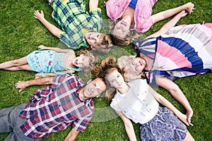 Big family relaxing in the summer park