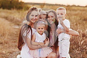 Big family is relaxing together in green nature. Mother`s Day. happy family together. two moms with children. selective focus