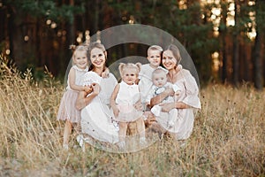 Big family is relaxing together in green nature. Mother`s Day. happy family together. two moms with children. selective focus