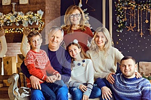 Big family in a room with a fireplace in Christmas.