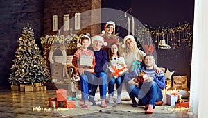 Big family in a room with a fireplace in Christmas.