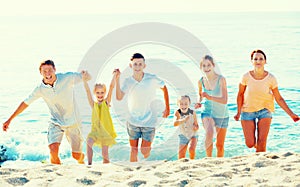 Big family running on beach