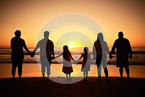 Big family silhouette on beach with sea waves, sunset on the horizon and holding hands for development wellness, support