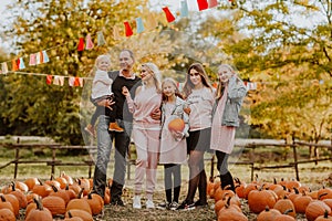 Big family spending time at the pumpkin`s farm. Fall time
