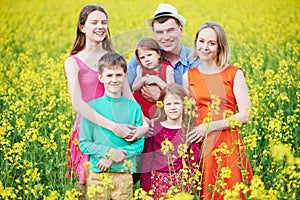 Big family in summer field outdoors.