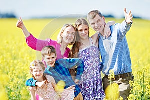 Big family in summer field outdoors.