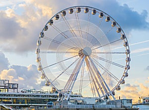 Big ferris wheel attraction at the pier of Scheveningen beach Holland a well-known and touristic town