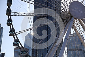 The big Ferris wheel in Central Hong Kong with commercial building behind