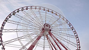 Big ferris wheel close up on a background of cirrus clouds. bottom View