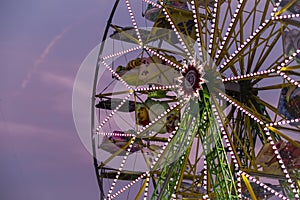 Big ferris Wheel at night during sunset in summer