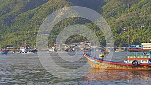 Big fisherman boats coming out of the port in Asia. Overfishing concept