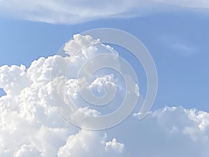 Beautiful big fluffy clouds with sunlight in blue sky