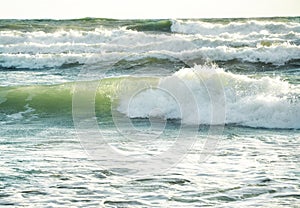 Big foamy sea waves movement on a seashore