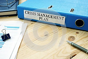Big folder with label Crisis Management Plan. photo