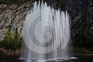 Big fontain by rock, walking in smallest medieval town in world Durbuy on river Ourthe, Ardennen, Belgium