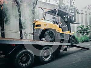 Big forklift truck move reverse to the big truck for transport a