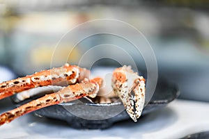 Big fresh tasty crab legs and claw chela in stylish grey plate