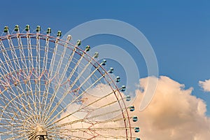 Big funfair ferris wheel with blue sky