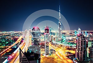 Big futuristic city with world tallest skyscrapers. Aerial nighttime skyline of Dubai, UAE.