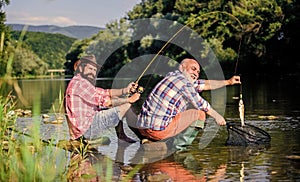 big game fishing. relax on nature. retired father and mature bearded son. happy fishermen friendship. Two male friends