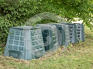 Big garden plastic composter bins in a garden in backyard outdoors