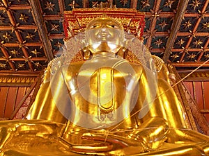 Big golden Buddha image in ancient Buddhist temple - Wat Phumin, Nan province, Thailand.