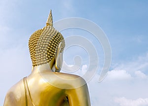 The big golden Buddha statue on clouds and sky.