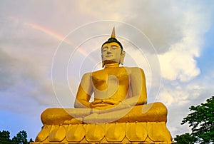 The big golden Buddha statue of Phu Salao temple with Mekong River flows through the Pakse city in beautiful sunset moment at Paks
